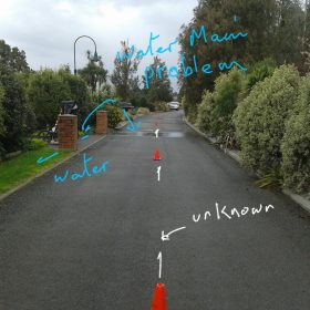 Picture of driveway with red lines showing where water pipes are beneath